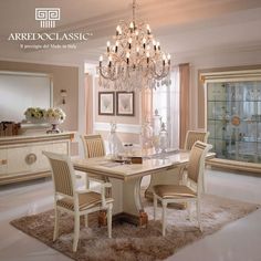 an elegant dining room with white furniture and chandelier