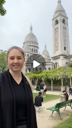 a woman standing in front of a large building