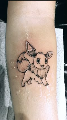 a small tattoo of a pokemon pikachu on the left forearm and right leg