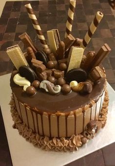 a chocolate cake with many different types of candies and candy on it's top