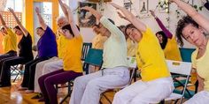 a group of people doing yoga in a room