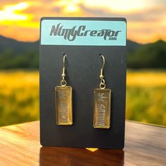 Elevate your style with our Laser Engraved Stainless Steel Dangle Earrings! Featuring "Sativa" on one earring and "Indica" on the other, these sleek and modern accessories are perfect for enthusiasts. Crafted from high-quality stainless steel, gold in color, they are durable, hypoallergenic, and lightweight. The minimalist design ensures they complement any outfit, making a bold statement without saying a word. Show off your unique taste and passion with these chic, engraved earrings. Gold Etched Earrings As Gift, Gold Etched Earrings For Gift, Gold Etched Dangle Jewelry, Gift Gold Etched Earrings, Engraved Metal Earrings As Gift, Engraved Metal Earrings For Gift, Engraved Earrings, Engraved Stainless Steel, Modern Accessories