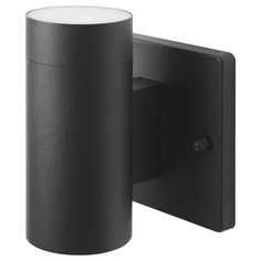 a black wall mounted light with a white cylinder on the front and back end,