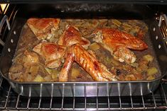 chicken and potatoes cooking in an oven