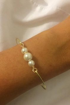 This listing is for one three pearl bangle. Made with high quality gold plated , tarnish resistant wire ,and (6 , 8 mm) swarovski ivory pearls. It comes in three different sizes. #bangles #bracelates #jewelry White Pearl Bangle As A Gift, Pearl Bangle As Gift, Gold Pearl Bangle As Gift, Gold Pearl Bangle For Gift, Gold Pearl Bangle Perfect As A Gift, Future Jewelry, Pearl Bangle, Past Present Future, Ivory Pearl