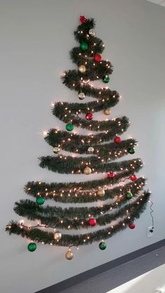 a decorated christmas tree hanging on the wall