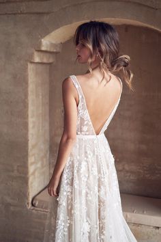 a woman in a wedding dress looking back