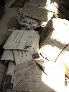 many old envelopes are piled on top of each other