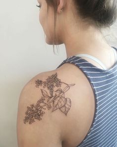 a woman with a flower tattoo on her shoulder