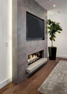 a living room with a large flat screen tv mounted on the wall and a fireplace