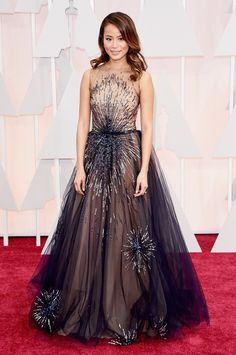 an image of a woman on the red carpet wearing a dress with flowers in it