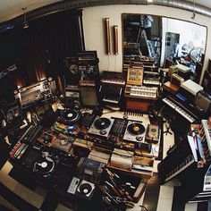 a room filled with lots of musical instruments and sound equipment on top of each other