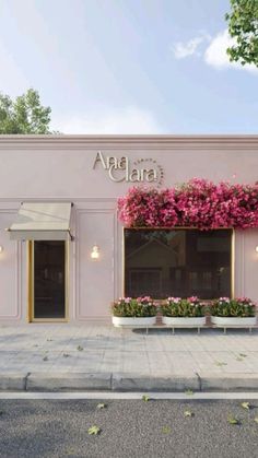 a pink building with purple flowers on the front and side windows that say ama clara