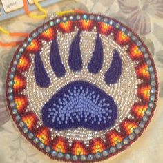 a beaded animal's paw is shown on a table