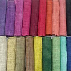 many colors of linens are lined up in rows