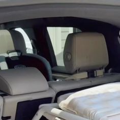 the interior of a car with an inflatable mattress and headrests on