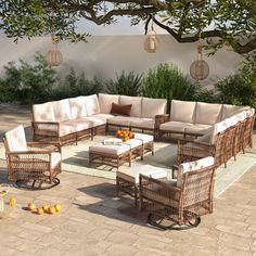 an outdoor seating area with wicker furniture and oranges on the ground next to it