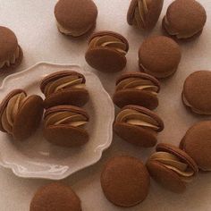 chocolate macaroons are arranged on a plate