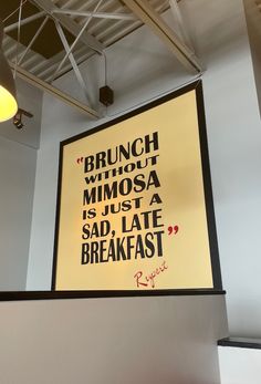 a large poster hanging on the wall above a table