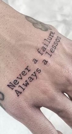 a person's hand with a tattoo on it and the words never always go