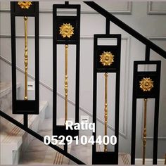 the stair railings are decorated with golden sunburst decorations and black metal posts