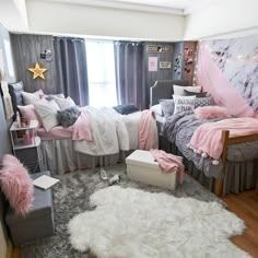 a bedroom decorated in pink and grey with white fur rugs on the floor, two twin beds