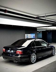 a black car parked in a parking garage