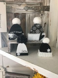 three hats are sitting on top of a shelf