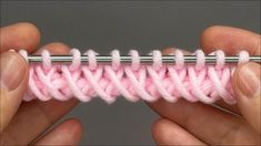 someone crocheting the stitchs together in pink and white