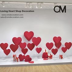 red hearts on display in front of a white wall