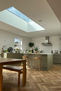 an open kitchen and dining room with skylights