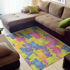 a living room filled with furniture and a colorful rug on top of the floor in front of a window