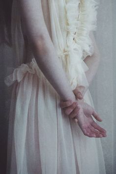 A photo of a young woman wearing a filmy white gown with her hands clasped behind her back. Laura Makabresku, Ange Demon, Hand Reference, Pale Skin, Up Girl, Lany, Photography Inspiration, Muse, A Woman