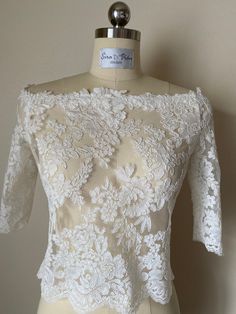 High quality materials, hand made lace top. French lace wedding dress top, relaxed fit, off the shoulder, satin covered buttons back closing. Re embroidery lace. Available in white and Ivory. At Sira D'Pion, all of our dresses can be customized to your specific needs and wants. ▪️Measurements needed are: bust, waist, hips, length. Resizing options and shortening are available for an extra charge. Sizes are the standard in the bridal industry and we can help you in your size selection by submitti Bridal Skirt Separate, Wedding Dress Top, Wedding Tops, French Lace Wedding Dress, Bridal Crop Top, Wedding Dress Topper, Dress Topper, Bridal Wardrobe, Bridal Skirts