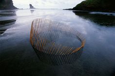 a large wooden object floating on top of a body of water