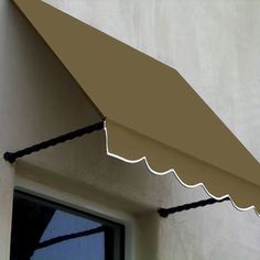 an awning on the side of a building with a window in front of it