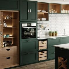 a kitchen with green cabinets and white tile backsplash, wooden flooring and open shelving