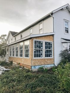 a house that has been boarded up and is in the process of being remodeled