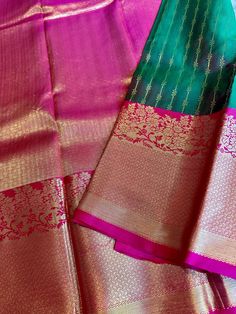 Super gorgeous, Traditional and festive , pure, silk mark certified Kanchi Silk saree. The saree is silk mark certified and comes with a contrast blouse piece and contrast pallu. Body is a lovely dual tone green and subtle hues of oil red in the mix. Border and pallu are a very detailed and intricate and lovely pink shade. Border is big border and has intricate craftsmanship. Falls, pico can be done for an extra price. Blouse stitching can be done at an additional price. Dual tone, grand, silk mark certified Kanchi Silk Saree with Big Border | kanchipuram silk | kanchi pattu online shopping usa | kanjivaram | ethnic | Diwali | bridal kanjivaram | navratri | Durga puja | pujo Green Traditional Wear With Zari Weaving For Celebration, Green Tissue Silk Traditional Wear For Celebration, Pink Silk Mark Certified Traditional Wear For Diwali, Festive Silk Mark Certified Traditional Wear For Diwali, Traditional Silk Mark Certified Wear For Wedding Festivals, Silk Mark Certified Traditional Wear For Weddings And Festivals, Festive Traditional Wear For Diwali, Silk Mark Certified, Bollywood Festive Traditional Wear, Silk Mark Certified Paithani Silk Traditional Wear For Wedding