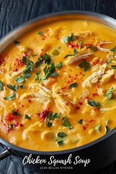 chicken and squash soup in a pan with parsley on the top, ready to be eaten