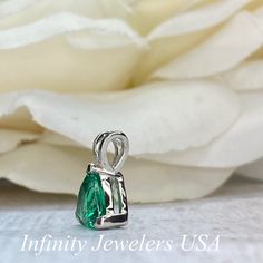 "The pendant pictured is a lab created emerald #6074 -Approximate total carat weight: approx. 1.80ctw diamond equivalent -Center Stone Size: 7x7mm - approx. 1.80ct diamond equivalent -Center Stone Shape: trillion -Gem Type: lab created emerald -Stone Clarity: VS2 -Stone Color: green -Moh's Scale: 8.5 hardness -Metal Type and Purity: 14k white gold -Setting: 3 prong basket head open back design -Chain: delicate 14k gold chain / heavier option with lobster claw available (use dropdown to select) - Pear-shaped Emerald Gemstone Necklace, Pear-shaped Emerald Necklace For Anniversary, Pear-shaped Emerald Necklace In White Gold For Anniversary, Pear-shaped Emerald Necklace May Birthstone, Anniversary White Gold Pear-shaped Emerald Necklace, Pear-shaped Emerald Necklace In White Gold, Pear-shaped Emerald Necklace Gift, Green Teardrop Brilliant Cut Jewelry, White Gold Pear-shaped Emerald Jewelry