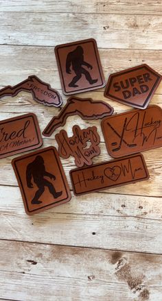 six wooden stickers with autographed images on them