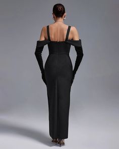 the back of a woman in a long black dress