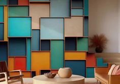 a living room filled with furniture next to a wall covered in multicolored squares