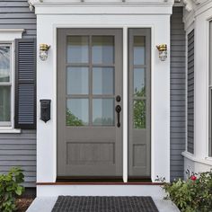 a gray front door with black shutters