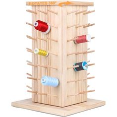 a wooden structure with several different thread spools