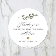 thank you for showering our baby with love round sticker on marble countertop