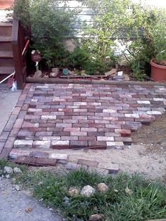 a brick patio with steps leading up to it