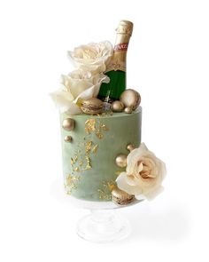 a cake decorated with flowers and champagne bottle