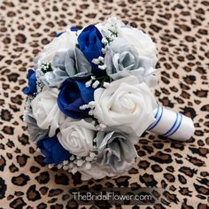 a bridal bouquet with blue and white flowers on a leopard print background at the bride's wedding